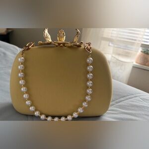 Elegant Gold Clutch with Pearl Strap